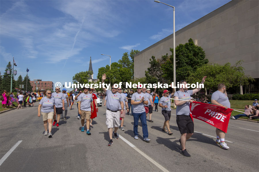 Corrie Svehla waves to the crowd as the Husker Pride entry walks down K Street during the June 19 parade. More than 20 members of the university community marched together during Lincoln's first Star City Pride parade. A number of campus administrators, including Chancellor Ronnie Green and his wife, Jane, participated in the walk around the Nebraska State Capitol. Star City Pride parade on June 19, 2021. Photo by Troy Fedderson / University Communication.